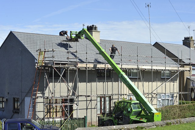 Roofers fixing a house roof with scaffold