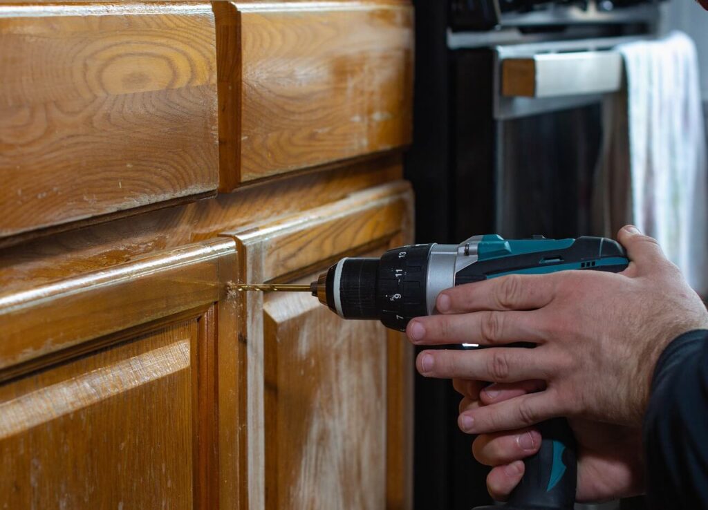 Electric drill drilling into wood